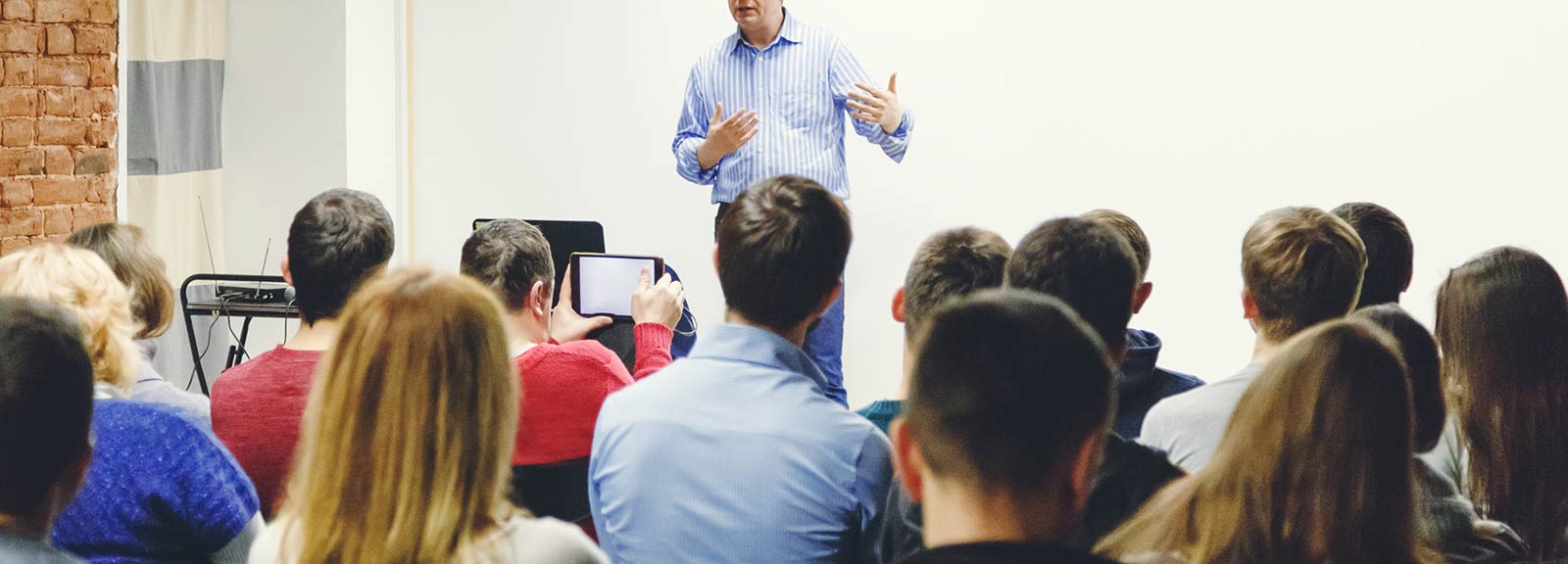 Man giving a lecture to group of people